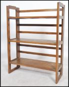 A 20th century retro folding table top display shelf. Slatted supports with folding panel wood