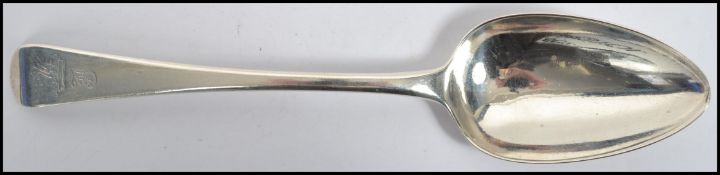 An early 19th century Georgian silver hallmarked basting table spoon of typical form being