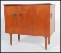 A 1970's teak record cabinet having a side door revealing a small storage area and a twin door to