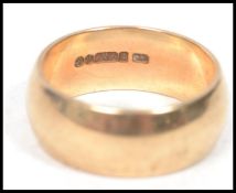 A hallmarked 9ct gold wedding band ring of plain form, weighs 4.8 grams size J.