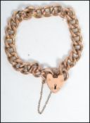 A vintage 9ct gold heart padlock bracelet chain each link stamped with the padlock hallmarked to