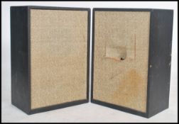 A large pair of vintage 20th century club style speakers in wooden cases with fabric facia's