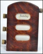 An early 20th century tortoise shell desk top perpetual calendar having three winding rolls for