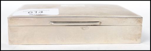 A vintage mid 20th century silver hallmarked cigarette tobacco box by Harman Brothers having an