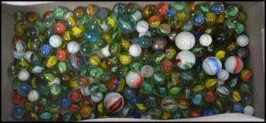 A shoe box full of vintage 20th century glass marbles to include cat eye, onion skin type etc.