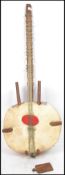 A vintage 20th century unusual large mandolin musical instrument having a wooden body with animal