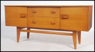 A vintage / retro 20th century teak wood sideboard having curved facia with 2 cupboards either