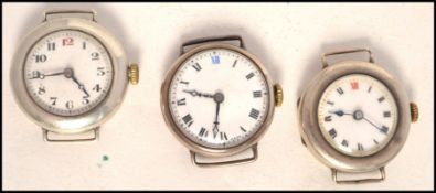 A group of 3 vintage early 20th century ladies silver wristwatches, each without straps. The watches