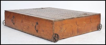 A vintage early 20th cenutry pine slatted storage bed box / coffee table raised on cast iron