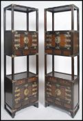 A pair of Chinese hardwood and brass upright pedestal cabinet stands. Each of upright form with