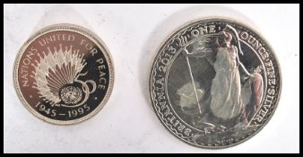 A  silver ounce 1995 United for Peace £2 coin together with another one ounce fine silver £2 coin.