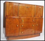 An early 20th Century art deco walnut cocktail - drinks cabinet of large proportions having a