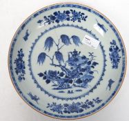 A 19th century Chinese blue and white bowl depicting a willow tree with scholars desk, floral sprays