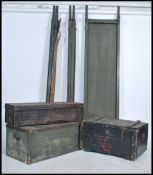 A collection of vintage 20th century tin and wooden military shipping trunks together with three