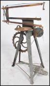 A vintage 20th century industrial Hobbies cast metal pedal foot powered fret saw raised on tripod