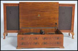 A mid century walnut cased Dynatro hi-fi music system with inset Garrard Mk IV record player. Walnut