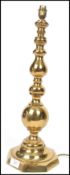 A vintage 20th century large brass candlestick table lamp raised on an octagonal base with bulbous