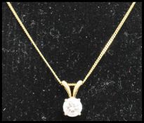 A hallmarked 18ct gold and solitaire diamond pendant necklace having a 50pt diamond strung on a 18ct