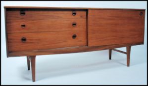 A 1970's Danish inspired retro sideboard raised on tapering legs having a bank of three drawers to