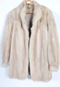A vintage 20th century ladies short white Mink fur evening coat with makers labels to the inner