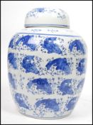 An Oriental Chinese ceramic ginger jar of large form having a blue and white carp decoration with