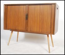 A mid 20th century retro Danish influenced cabinet sideboard unit with twin tambour doors raised