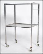 An original mid century Industrial surgeons theatre trolley of tubular metal and stainless steel