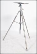 A vintage metal tripod based projector stand having a pivoting flat tray to top and baring applied