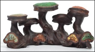A believed Chinese asiatic bronze brush set in the form of toadstools being inset ith jade and amber