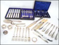 A collection of hallmarked silver items and silver plated flat ware to include cased sets, cake