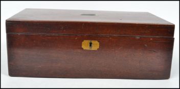 A 19th century Victorian mahogany writing slope having brass cartouche and escutcheon,the hinged lid