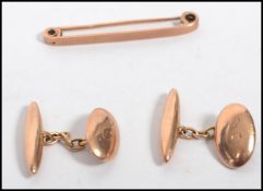 A hallmarked 9ct gold tie clip along with a pair of hallmarked 9ct gold monogrammed cuff links of