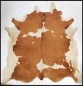 A retro 20th century large pony skin hide rug having brown and white fur ( see illustrations )