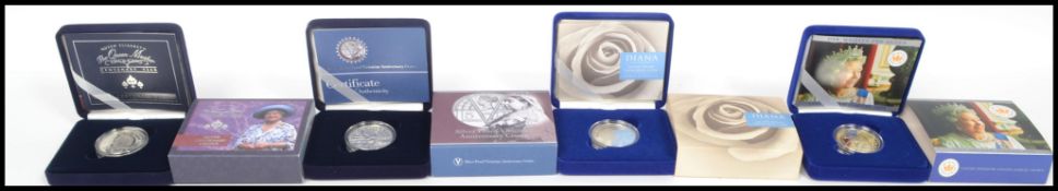 A group of four Royal Mint Silver Proof Crowns to include Her Majesty The Queen 1952 Golden