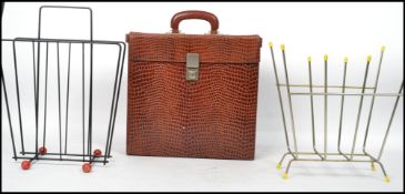 Two vintage 20th century retro sputnik atomic style magazine racks one having an ebonised finish