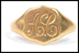A hallmarked 18ct gold signet ring having a monogrammed armorial shield. Weighs 3.5 grams size N.