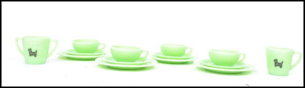 An early 20th century Art Deco vaseline glass coffee set having dog pictorials to each piece to