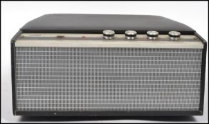 A vintage 20th century portable four speed record player by ITT KB. Lift up lid, built in speaker