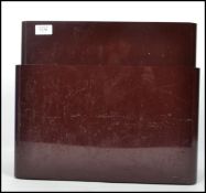 A vintage 20th century art deco style plastic magazine rack of graduating form having two raised