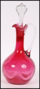 A believed 19th century Victorian cranberry glass dimpled decanter with the clear glass stopper in