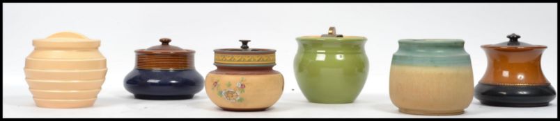 A group of early 20th century tobacco jars to include Denby, Royal Winton etc. Each with lids.
