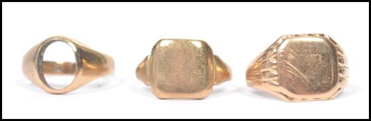 A group of three hallmarked 9ct gold signet rings to include two having plain armorial cartouche
