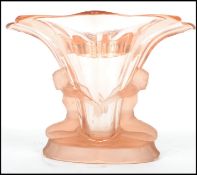 A vintage early 20th century pressed amber coloured glass of diamond form raised on a tapering body,