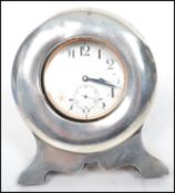 A silver hallmarked easel backed pocket watch stand of circular form with pocket watch having an