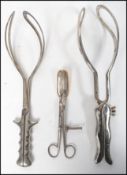 A collection of vintage 20th century medical midwifery and surgical tools to include forceps,