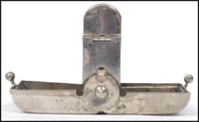 An early 20th century travelling silver plated pocket ink well. In the form of a purse having