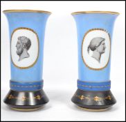 A pair of late 19th century French glass handpainted vases having powder blue grounds with pictorial