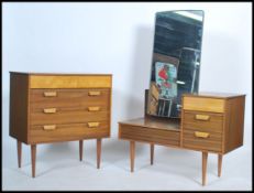A retro 1960's teak wood dressing table and chest of drawers combination bedroom set each being