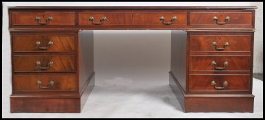 A good 20th century mahogany partners desk, leather tooled inlaid top, inverted breakfront, one long