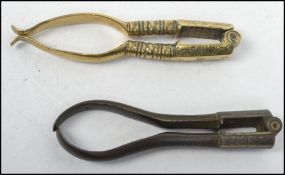 Two pairs of 18th century Georgian brass nutcracker of typical form stamped TB. Measures 11cm long.